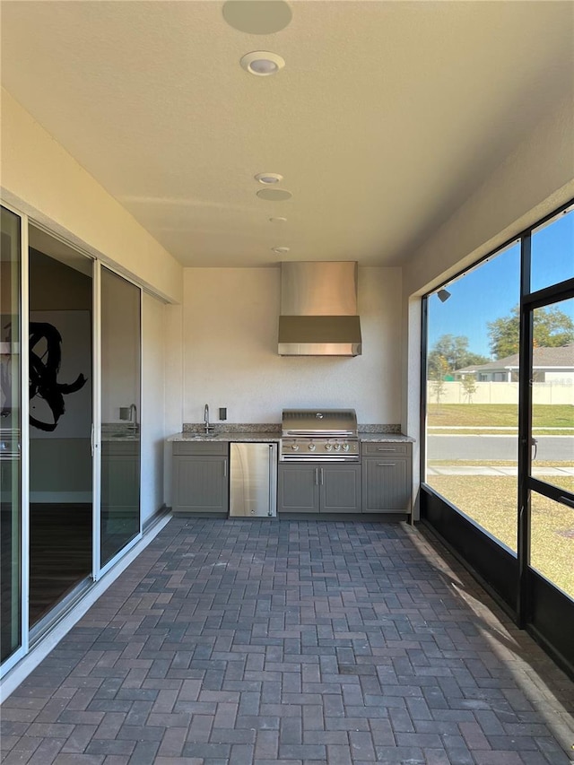 unfurnished sunroom with a sink