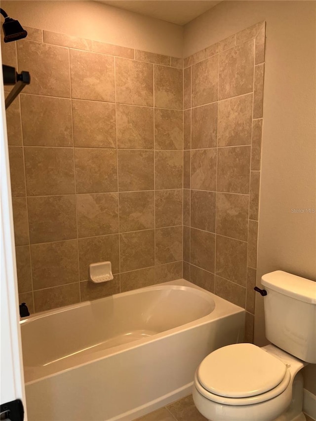 bathroom featuring toilet, bathtub / shower combination, and tile patterned flooring