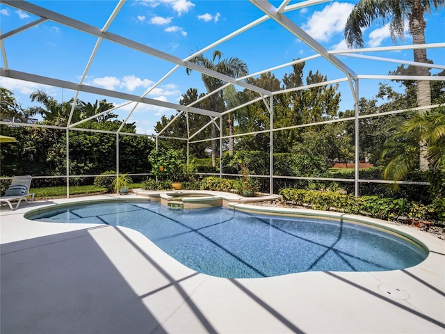 view of pool featuring a lanai, a pool with connected hot tub, and a patio