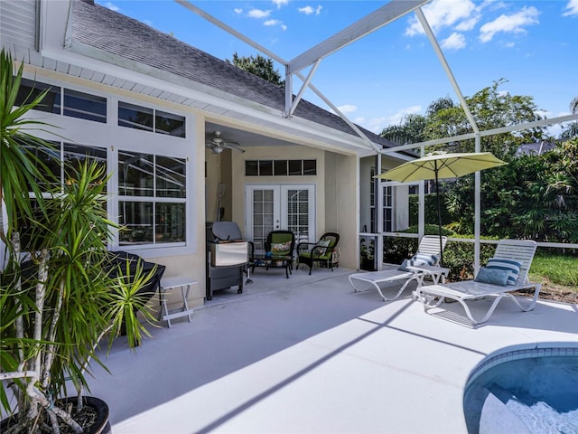 exterior space featuring an outdoor pool, french doors, ceiling fan, and glass enclosure