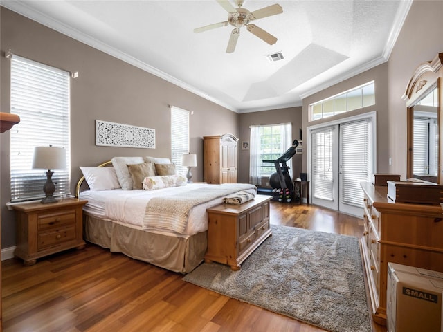 bedroom featuring wood finished floors, visible vents, ceiling fan, access to exterior, and crown molding