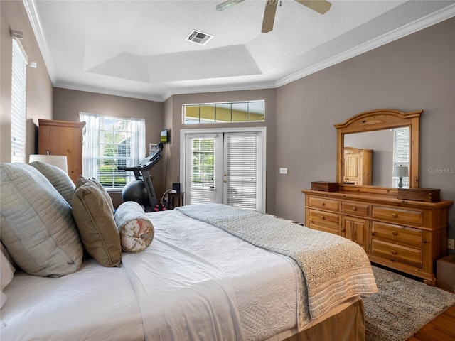 bedroom featuring visible vents, ornamental molding, access to outside, wood finished floors, and ceiling fan