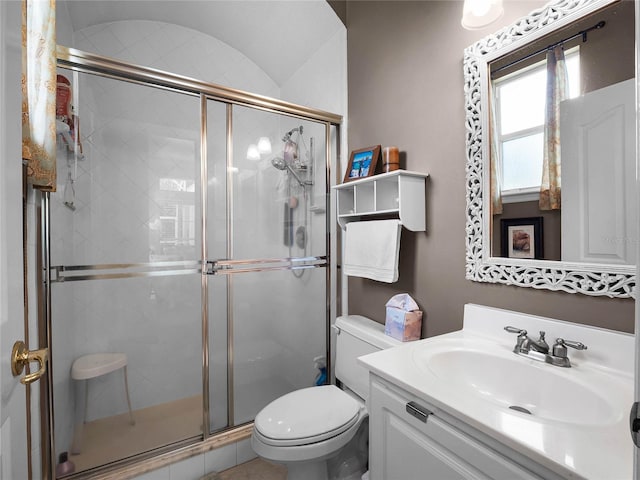 bathroom with vanity, toilet, and a shower stall