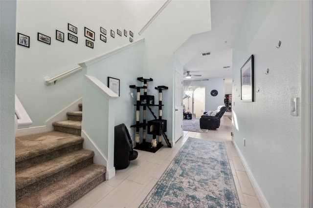 entryway featuring stairway, baseboards, and a ceiling fan