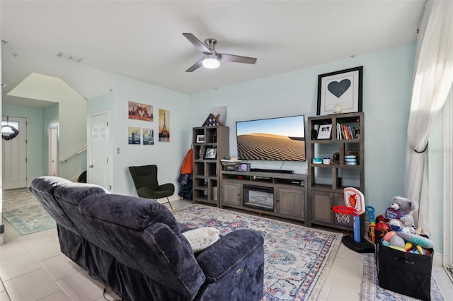 living area featuring light tile patterned floors, visible vents, and a ceiling fan