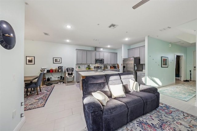 living area featuring recessed lighting, visible vents, and light tile patterned floors