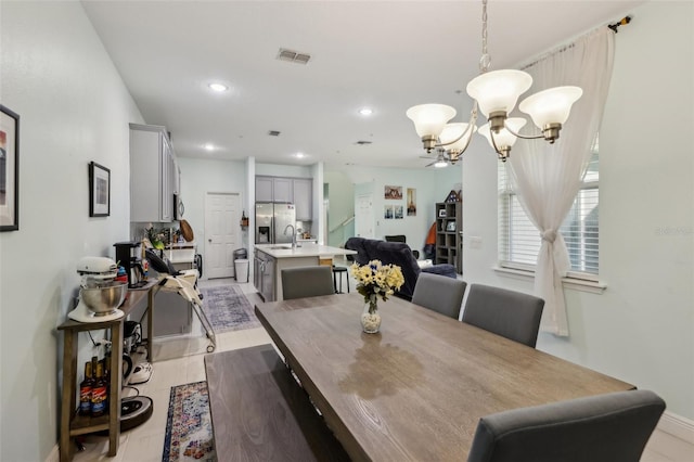 dining space featuring a chandelier, visible vents, recessed lighting, and baseboards