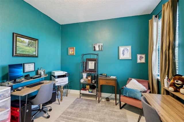 office space featuring baseboards, a textured ceiling, and tile patterned flooring