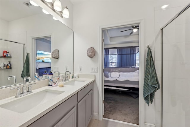 bathroom with a sink, visible vents, tiled shower, and ensuite bath