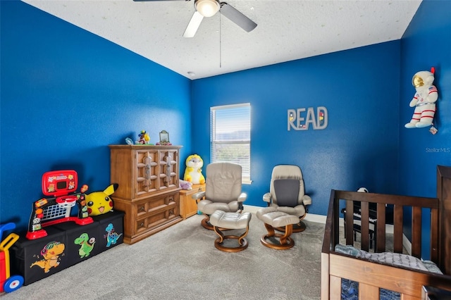 carpeted bedroom with a textured ceiling and a ceiling fan