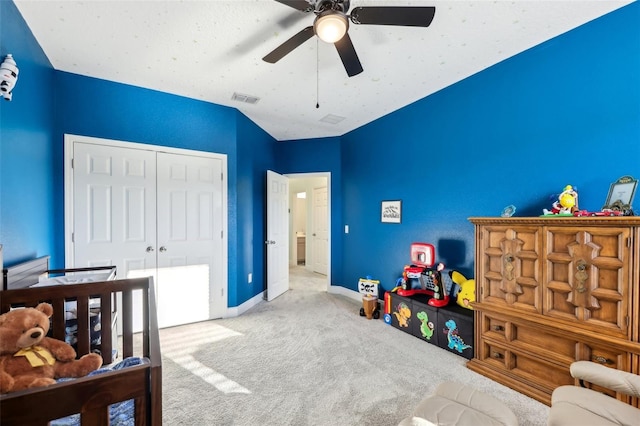 carpeted bedroom featuring baseboards, visible vents, a closet, and ceiling fan