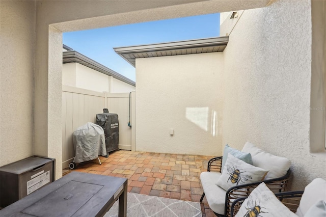 view of patio featuring area for grilling and fence