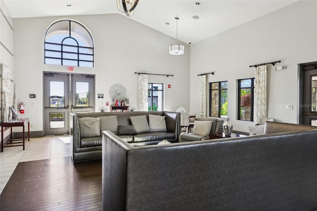 living room featuring french doors, wood-type flooring, and high vaulted ceiling