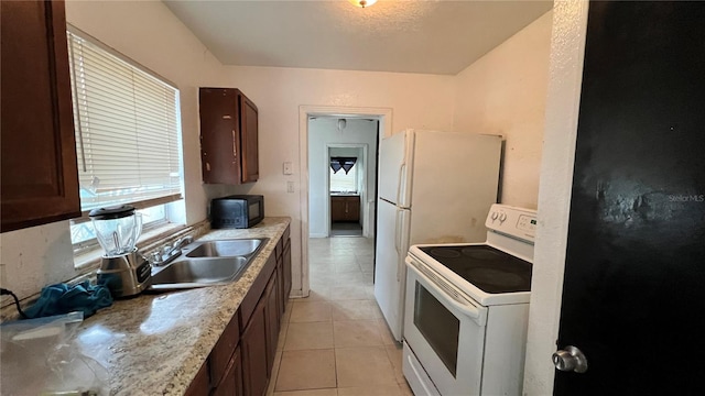 kitchen featuring white electric range, a sink, light tile patterned flooring, black microwave, and light countertops