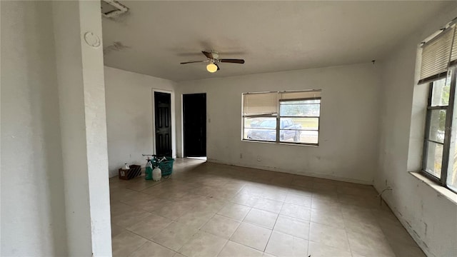 unfurnished room with light tile patterned flooring and ceiling fan