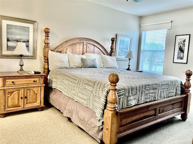 bedroom featuring light carpet and a textured ceiling