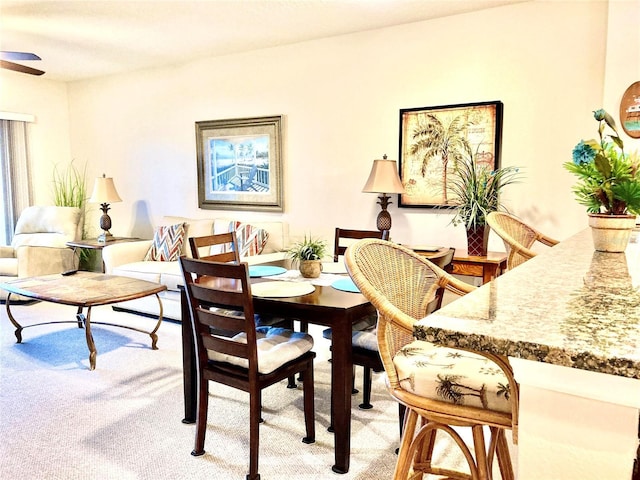 dining room featuring light colored carpet and ceiling fan