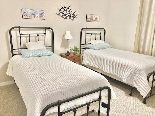 bedroom featuring carpet and baseboards