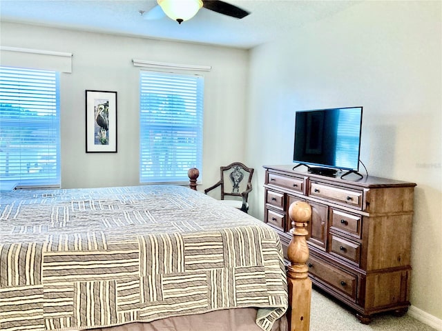 bedroom featuring baseboards, ceiling fan, and light colored carpet