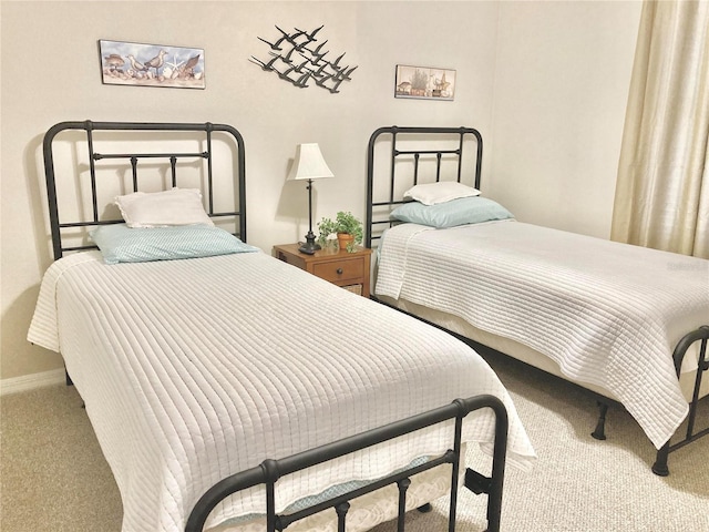 carpeted bedroom featuring baseboards