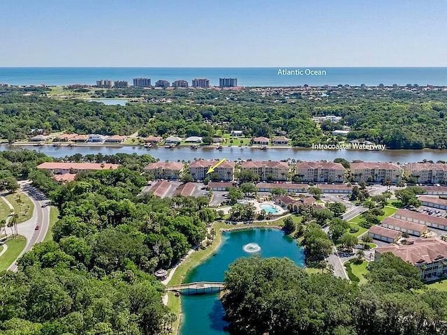 birds eye view of property with a water view