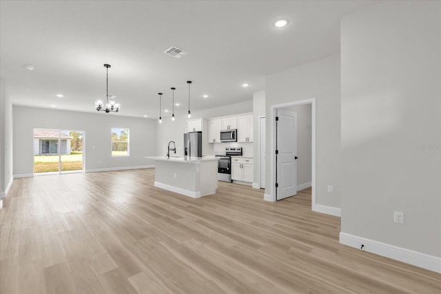 unfurnished living room with recessed lighting, a sink, visible vents, light wood-style flooring, and a notable chandelier