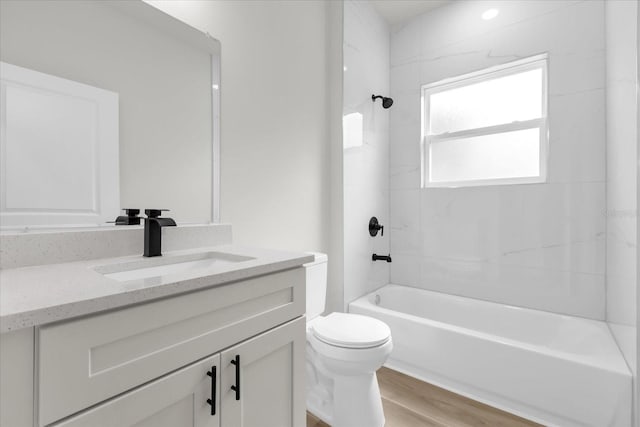 bathroom with toilet, vanity, shower / bath combination, and wood finished floors