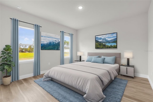 bedroom with baseboards, light wood-style floors, and recessed lighting