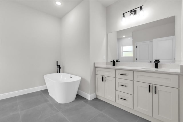 bathroom featuring double vanity, a sink, tile patterned flooring, and a soaking tub