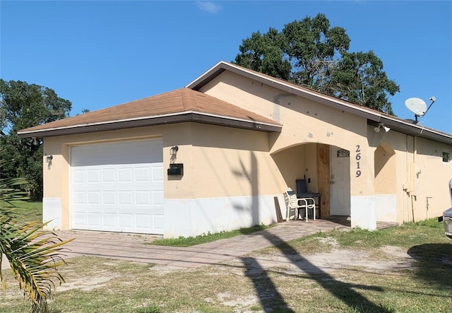 exterior space featuring stucco siding and an attached garage