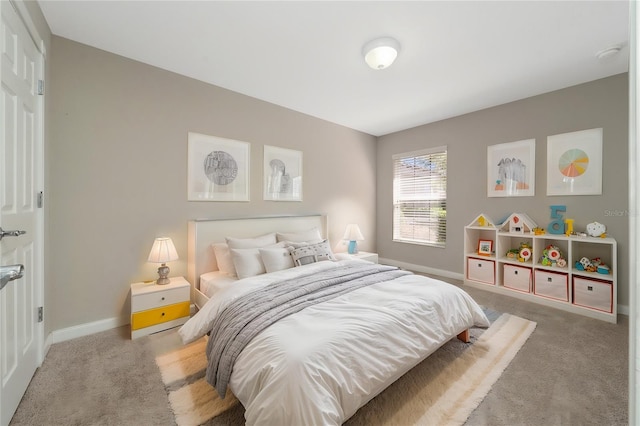 carpeted bedroom featuring baseboards