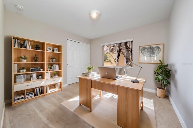 home office featuring baseboards and light colored carpet