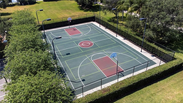 view of sport court with community basketball court, a yard, and fence