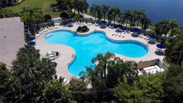 community pool with a patio and fence