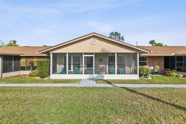 1001 Plantation Dr Unit D5, Kissimmee, FL 34741 - rear view of house with a lawn and a sunroom