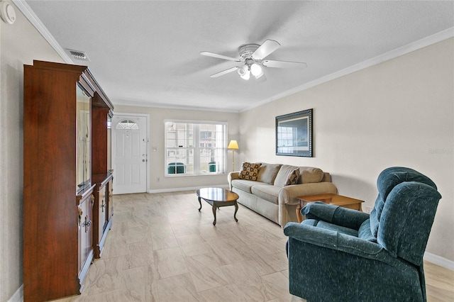 living area featuring visible vents, baseboards, ornamental molding, and a ceiling fan