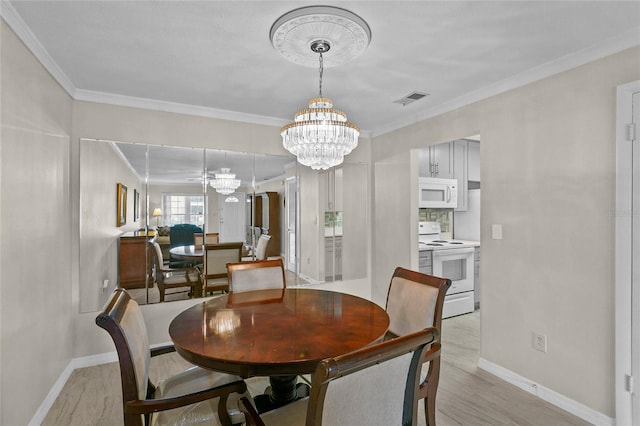 dining area featuring visible vents, baseboards, ornamental molding, light wood-style flooring, and a notable chandelier