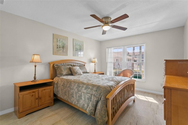 bedroom featuring baseboards and ceiling fan