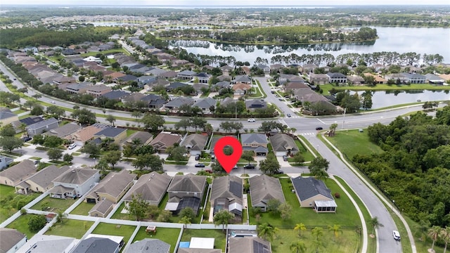 birds eye view of property with a water view and a residential view