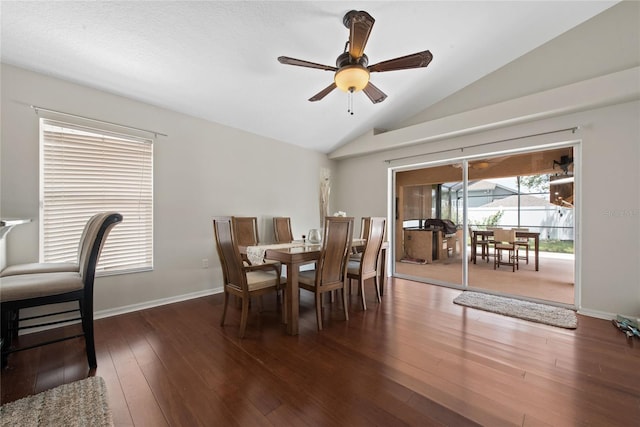 dining space with vaulted ceiling, a ceiling fan, baseboards, and wood-type flooring