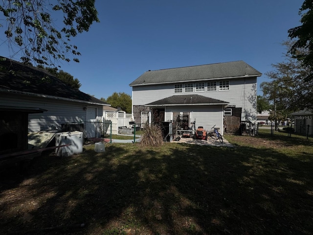 back of house with a patio, a yard, and fence