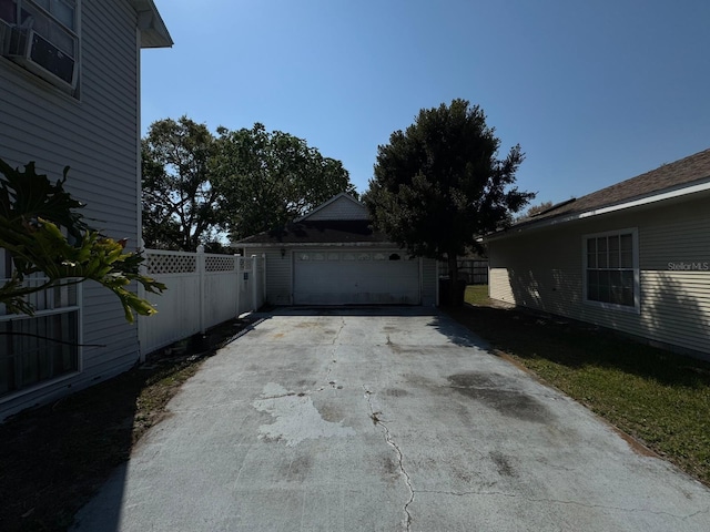 detached garage featuring fence