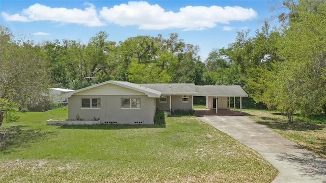 ranch-style house featuring a carport, concrete driveway, and a front yard