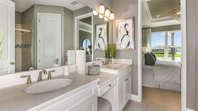 full bath featuring double vanity, visible vents, crown molding, and a sink