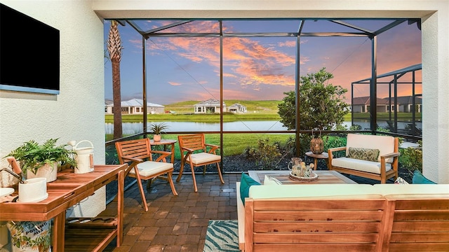 sunroom / solarium featuring a water view