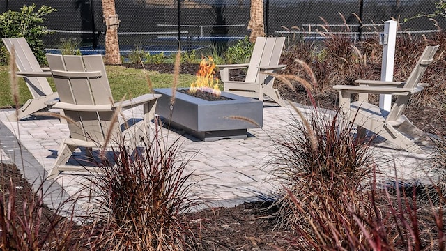 view of patio with a fire pit and fence