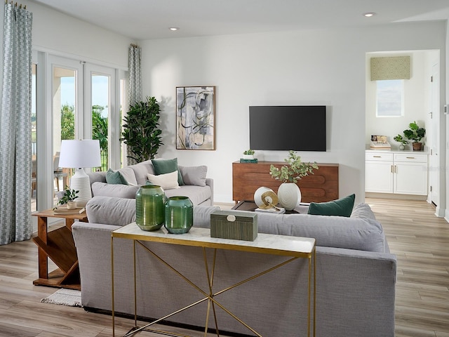 living area featuring recessed lighting and light wood-style floors