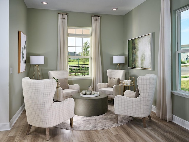 living area with recessed lighting, baseboards, and wood finished floors