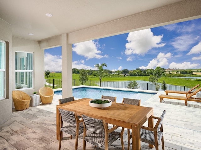 view of pool with a fenced backyard, outdoor dining space, a fenced in pool, and a patio