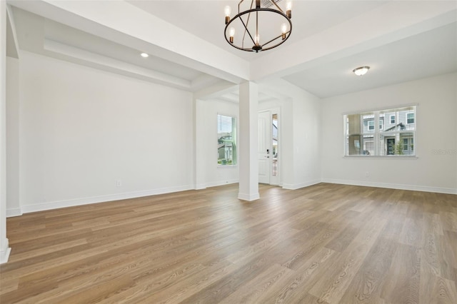 16354 Silver Grove Blvd, Winter Garden, FL 34787 - unfurnished living room with plenty of natural light, a chandelier, light wood-style floors, baseboards, and recessed lighting